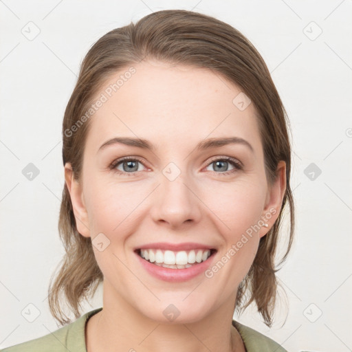 Joyful white young-adult female with medium  brown hair and grey eyes