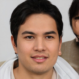 Joyful asian young-adult male with short  brown hair and brown eyes