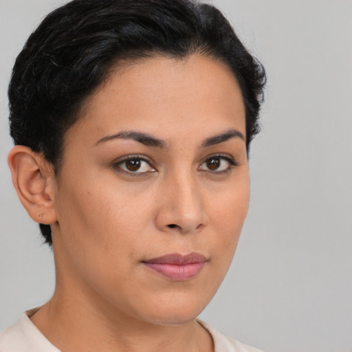Joyful latino young-adult female with short  brown hair and brown eyes
