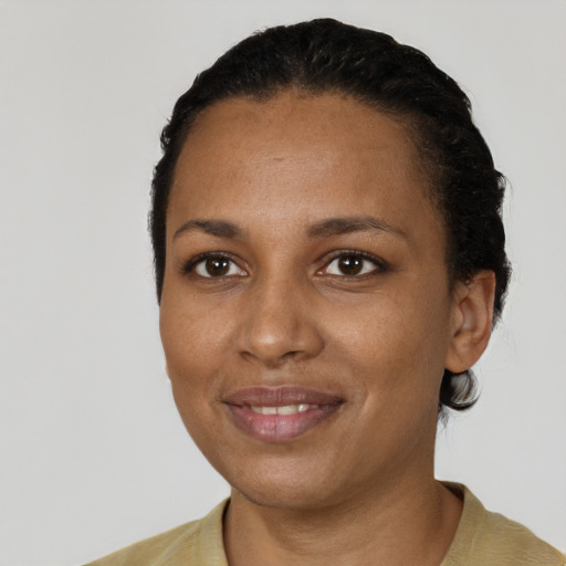 Joyful black adult female with short  black hair and brown eyes