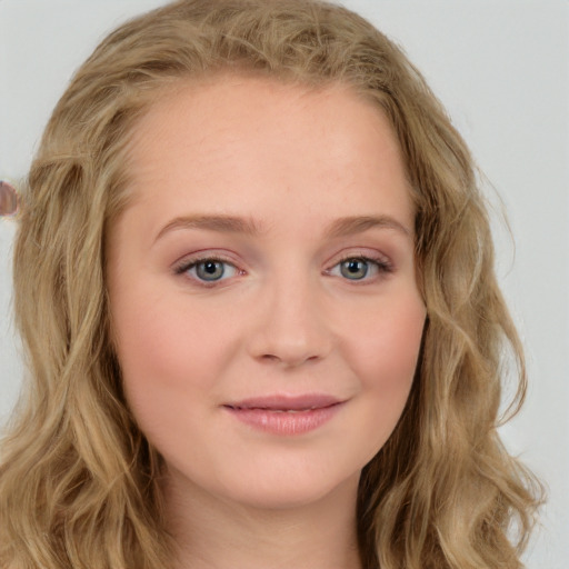 Joyful white young-adult female with long  brown hair and blue eyes