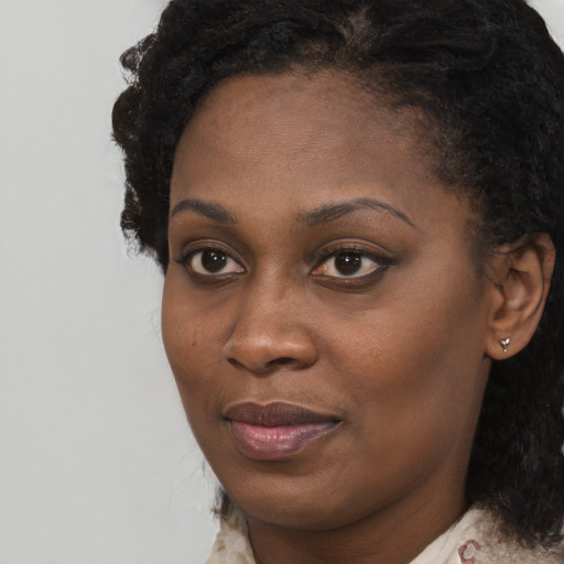 Joyful black young-adult female with medium  black hair and brown eyes