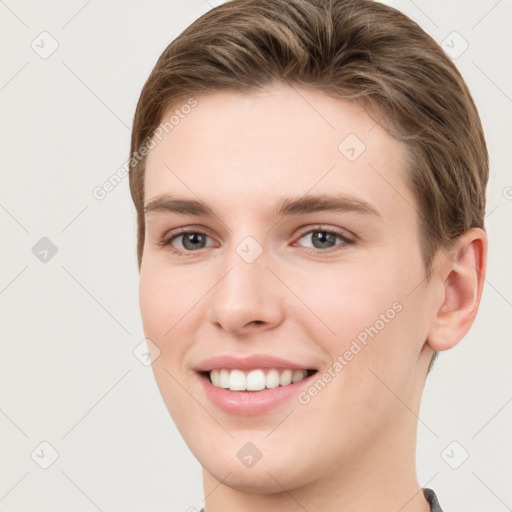 Joyful white young-adult female with short  brown hair and grey eyes