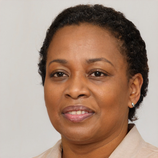Joyful black adult female with short  brown hair and brown eyes