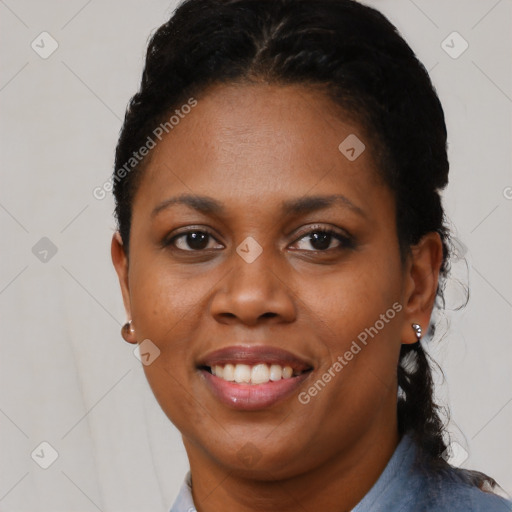 Joyful black young-adult female with short  black hair and brown eyes