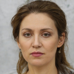 Joyful white adult female with medium  brown hair and grey eyes