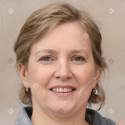 Joyful white adult female with medium  brown hair and grey eyes