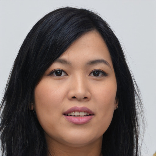 Joyful asian young-adult female with long  black hair and brown eyes