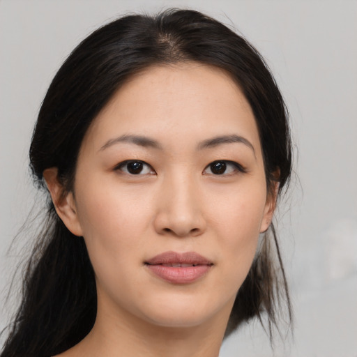 Joyful asian young-adult female with medium  black hair and brown eyes