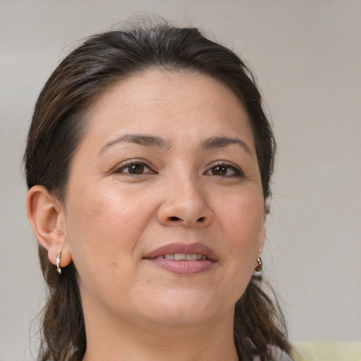 Joyful white adult female with medium  brown hair and brown eyes