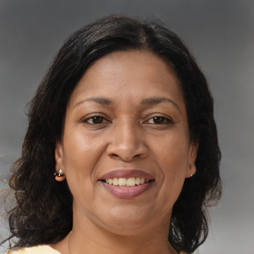 Joyful latino adult female with medium  brown hair and brown eyes