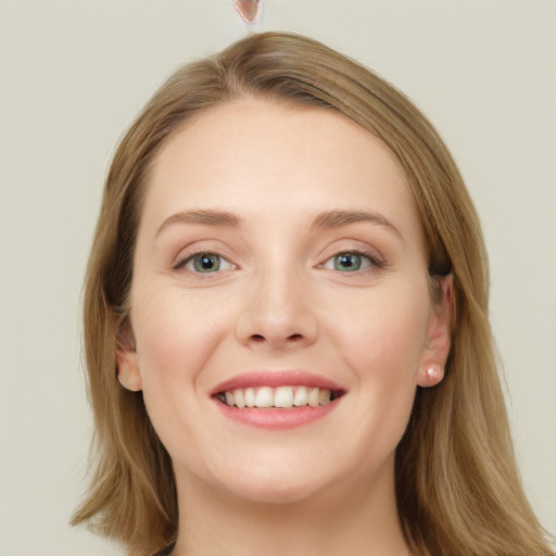 Joyful white young-adult female with long  brown hair and green eyes