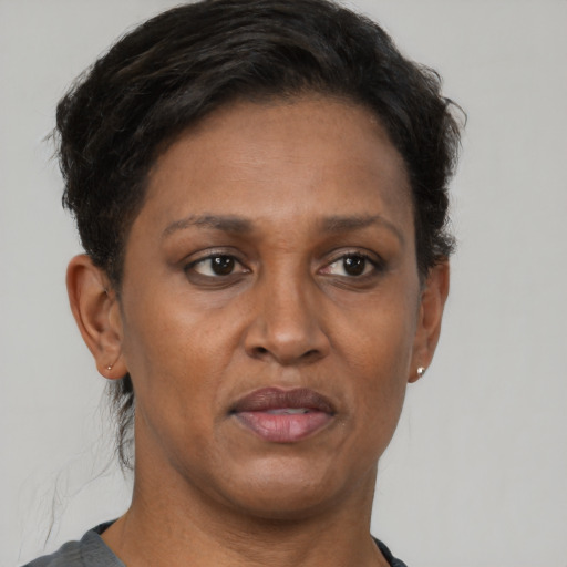 Joyful black adult female with short  brown hair and brown eyes