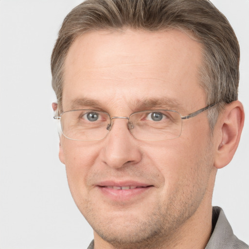 Joyful white adult male with short  brown hair and grey eyes