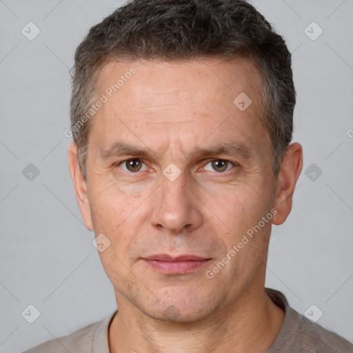 Joyful white adult male with short  brown hair and brown eyes