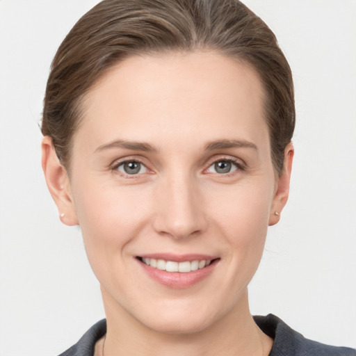 Joyful white young-adult female with medium  brown hair and grey eyes