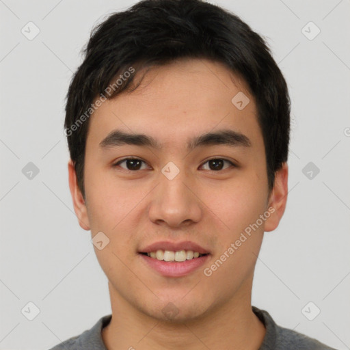 Joyful asian young-adult male with short  black hair and brown eyes