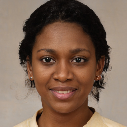 Joyful black young-adult female with medium  black hair and brown eyes