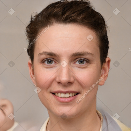 Joyful white young-adult female with short  brown hair and grey eyes