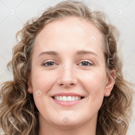 Joyful white young-adult female with long  brown hair and blue eyes