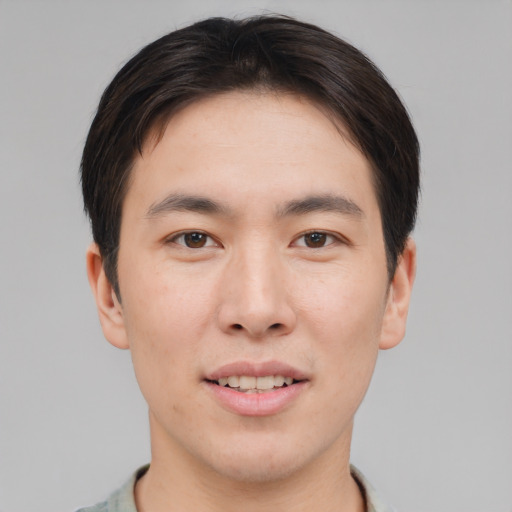 Joyful asian young-adult male with short  brown hair and brown eyes