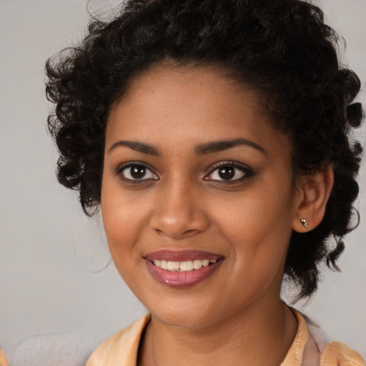 Joyful black young-adult female with medium  brown hair and brown eyes