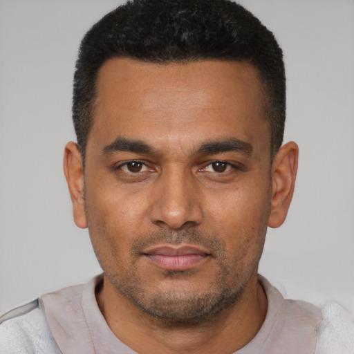 Neutral latino young-adult male with short  black hair and brown eyes