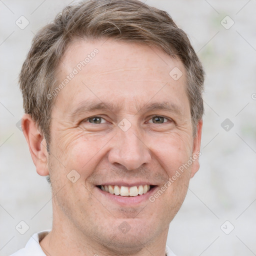 Joyful white adult male with short  brown hair and grey eyes