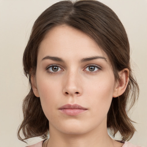 Neutral white young-adult female with medium  brown hair and brown eyes