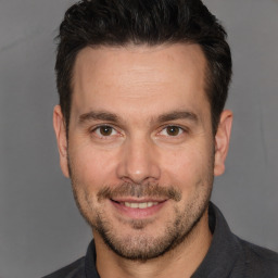 Joyful white adult male with short  brown hair and brown eyes