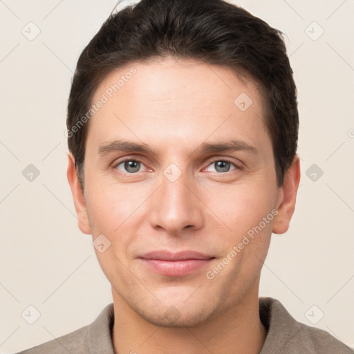 Joyful white young-adult male with short  brown hair and grey eyes