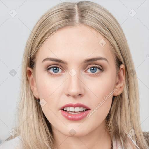 Joyful white young-adult female with long  brown hair and blue eyes