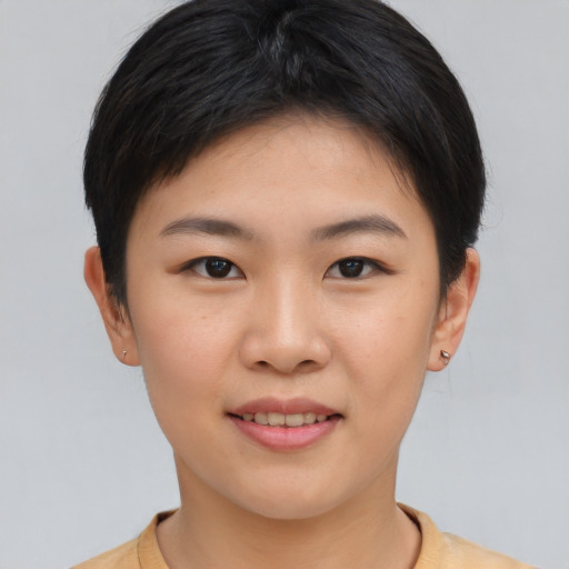 Joyful asian young-adult female with short  brown hair and brown eyes
