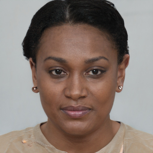 Joyful black young-adult female with short  brown hair and brown eyes