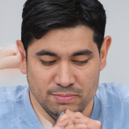 Joyful white adult male with short  black hair and brown eyes