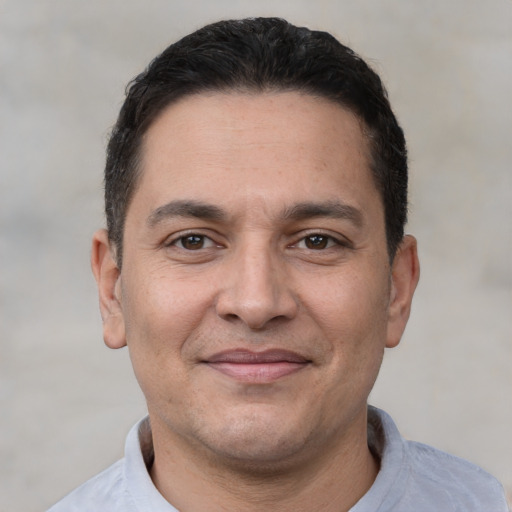 Joyful white adult male with short  brown hair and brown eyes