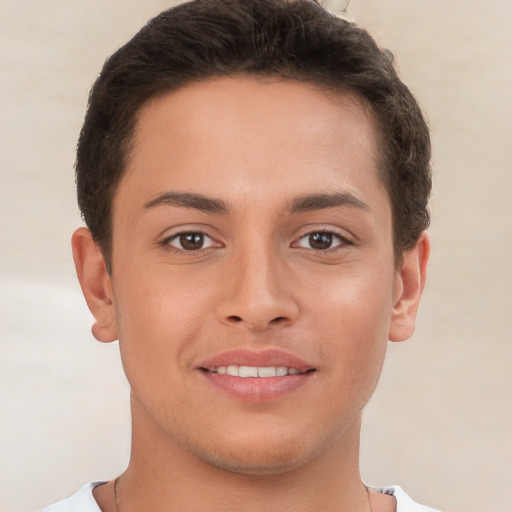 Joyful white young-adult male with short  brown hair and brown eyes