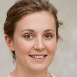 Joyful white young-adult female with medium  brown hair and green eyes