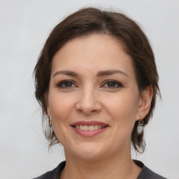 Joyful white young-adult female with medium  brown hair and brown eyes