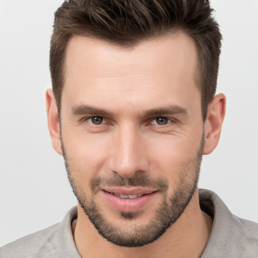 Joyful white young-adult male with short  brown hair and brown eyes