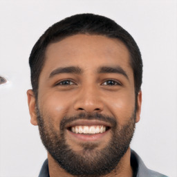 Joyful latino young-adult male with short  black hair and brown eyes