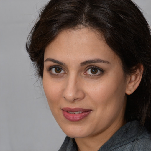Joyful white adult female with medium  brown hair and brown eyes