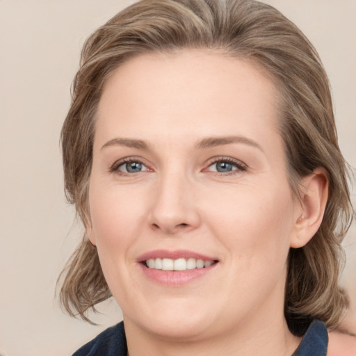 Joyful white young-adult female with medium  brown hair and blue eyes