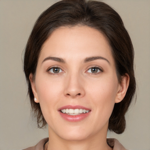 Joyful white young-adult female with medium  brown hair and brown eyes