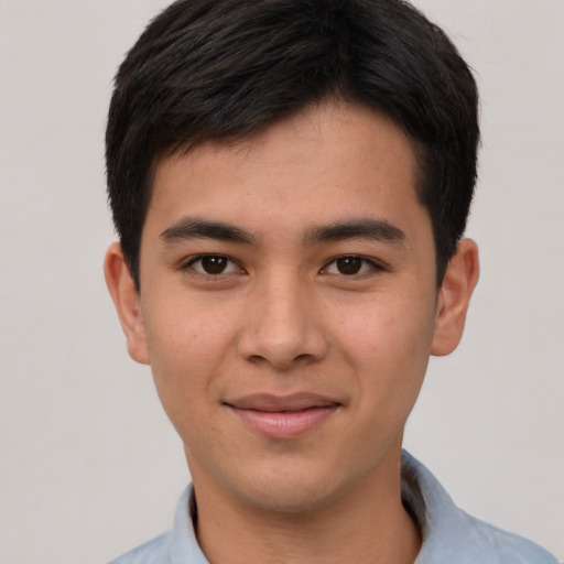 Joyful asian young-adult male with short  brown hair and brown eyes