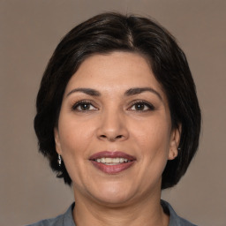 Joyful white adult female with medium  brown hair and brown eyes