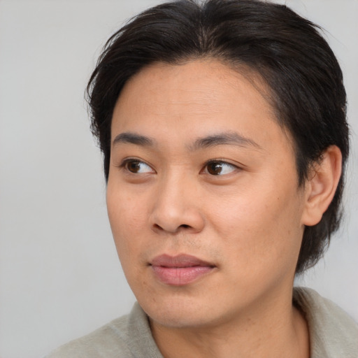 Joyful asian young-adult female with short  brown hair and brown eyes