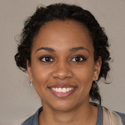 Joyful black young-adult female with medium  brown hair and brown eyes