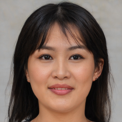 Joyful asian young-adult female with medium  brown hair and brown eyes