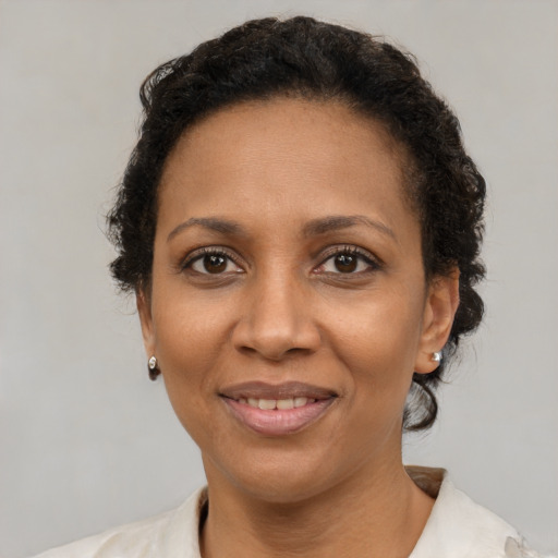 Joyful black adult female with short  brown hair and brown eyes